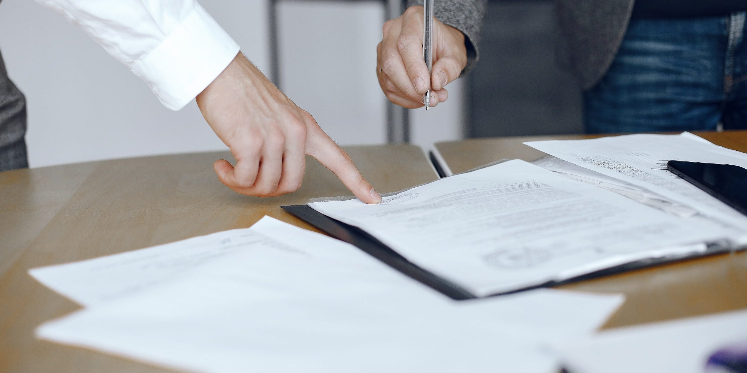 Two business partners signing a document Two business partners signing a document