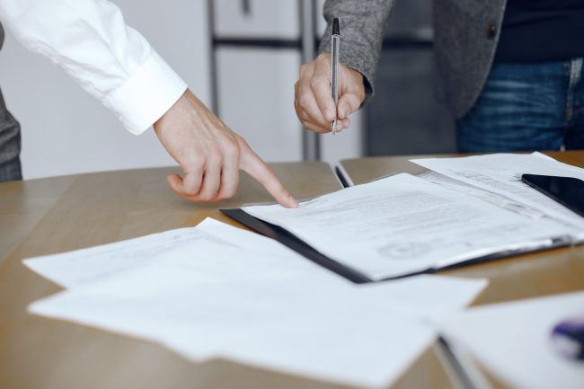 Two business partners signing a document Two business partners signing a document